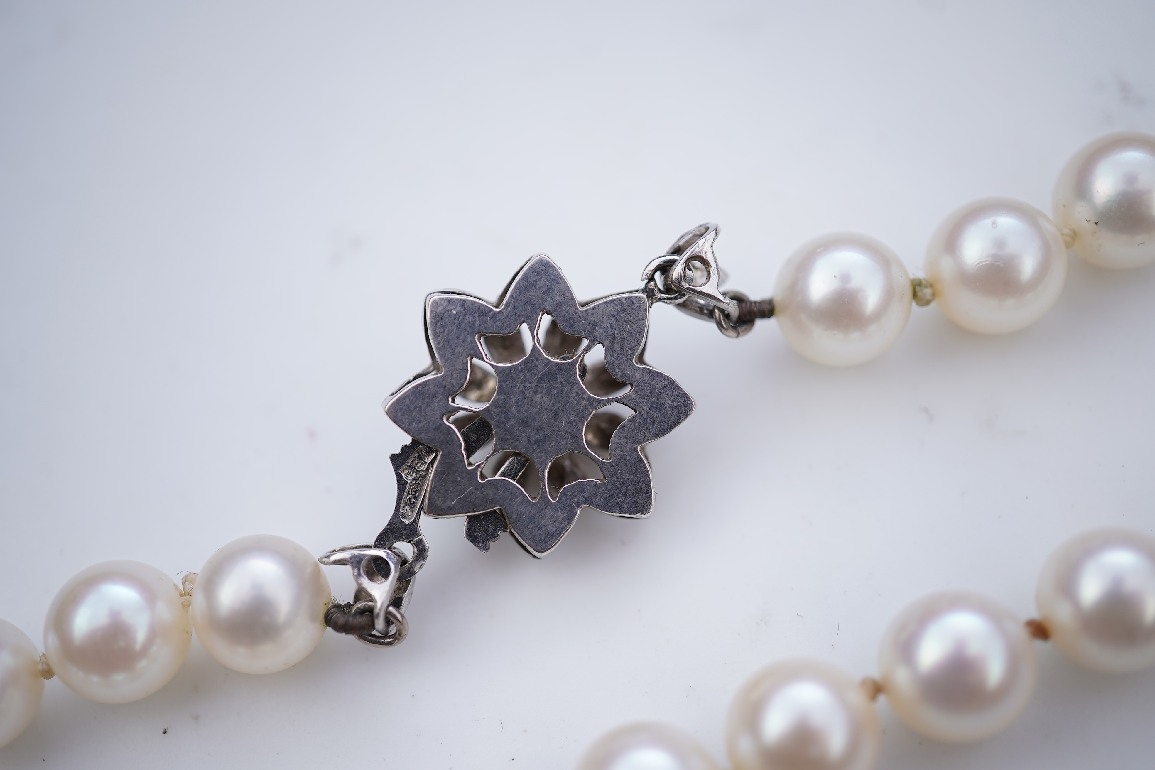 A cultured pearl necklace and pair of mabé cultured pearl ear clips